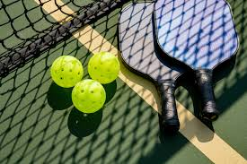 Pickleball paddles and balls on court